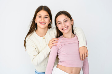 Two cute and Young pre teen girl on studio white