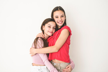 Two cute and Young pre teen girl on studio white