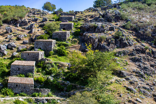 Stunning cascade of 18th century traditional stone water mills at Muinos do Folon e do Picon built with granite masonry, O Rosal, Pontevedra, Spain