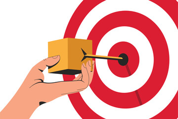 Hand holds small box struck by arrow hitting the bullseye center of red target.