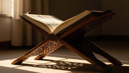Open Quran on wooden stand indoors.