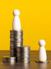 Wooden figures demonstrating economic inequality and social status
