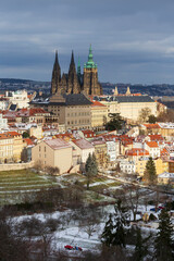 Obraz premium Snowy Prague Lesser Town with gothic Castle from Hill Petrin, Czech Republic 