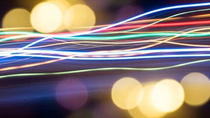 Abstract, motion-blurred light trails on a defocused bokeh background