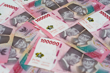 Indonesian 100 thousand rupiah banknotes background showing national currency, finance concept, cash money pattern for economy, business, investment, and financial design