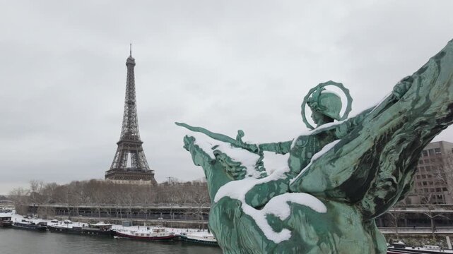 La France renaissante statue and the Eiffel Tower with snow