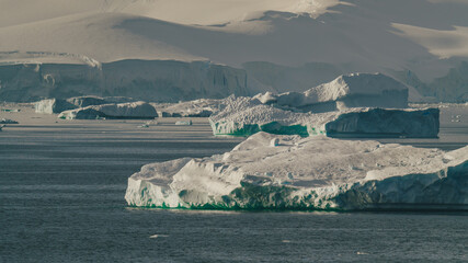 Antarctica Icebergs Float In Front of Charlotte Bay Beautiful Landscape Scene Early Morning Light. Snow and Ice Glacier Nature. © And They Travel