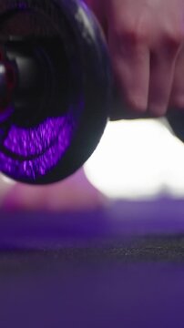 Female hands with polished nails pick up dumbbell weights