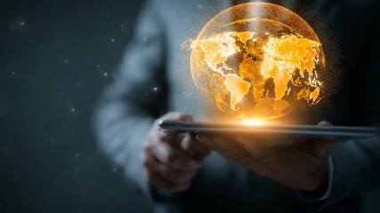 Businessman holding a tablet with a glowing orange world map on the screen - Powered by Adobe