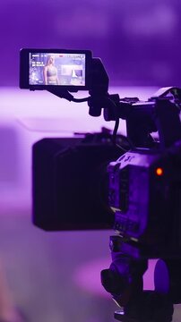 Female fitness influencer at home recording video with professional camera