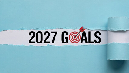 2027 Goals Text Revealed Behind Torn Blue Paper with Target Symbol