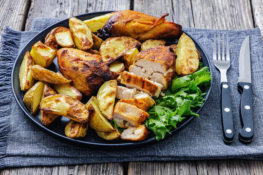 grilled juicy chicken breasts and roasted potatoes