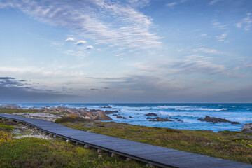 Obraz premium Meeting point of Atlantic and Indian Ocean in Cape Agulhas, South Africa. Garden Route