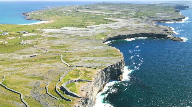 Aerial of Inis M&oacute;r Arran Island with cliffs and ruins of Dun Aengus ancient stone fort Ireland