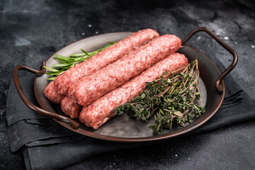 Fresh minced beef and lamb kebabs with fresh spices, arabic kofta kofte kebab. black background. top view © Mironov