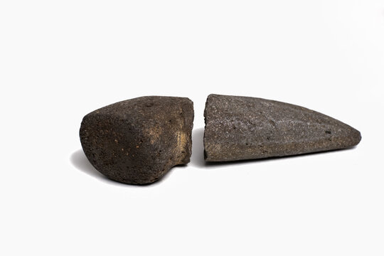 A broken stone pestle (Cobek and Ulekan) isolated on a white background. It is a typical Indonesian kitchen utensil to make chili sauce or cooking spices