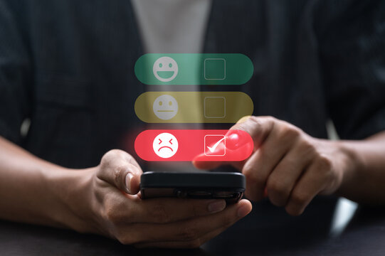 Person giving bad feedback on smartphone with digital rating interface showing low satisfaction, negative experience for negative customer experience or service complaint evaluation