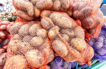 Fresh potatoes packed in bags selling at the grocery store