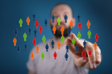 Conceptual image of a man touching a screen with a selection of people, representing connection and audience engagement.