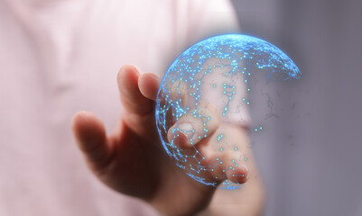 Person holding illuminated digital globe, representing global network, innovation, and technological advancement in a close-up shot.