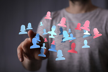 Hand touching digital representation of a social network connecting people. Concept of teamwork, collaboration, and online community.