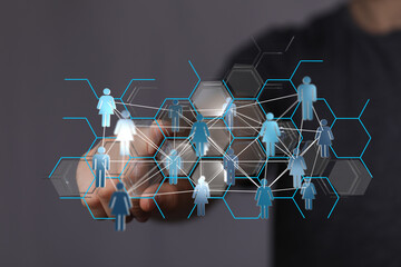 Hand touching digital human figures, representing network connections, technology, and global community. Ideal