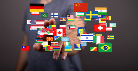 A person's hand reaching out holding a network of world flags, symbolizing global unity, communication, and international relationships. Promoti