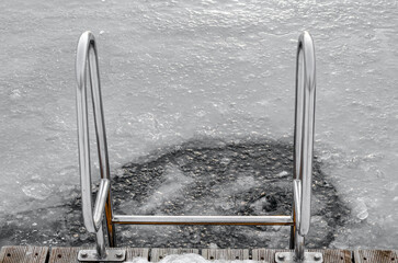 the pool ladder in frozen lake
