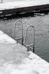 the pool ladder in frozen lake