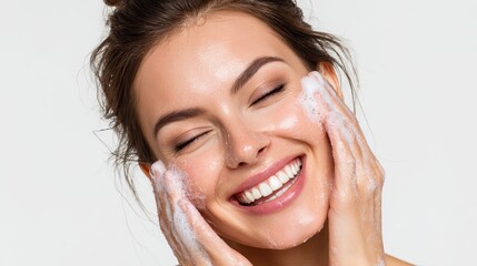 Image of a happy woman using facial cleanser Attractive brunette in a skincare spa setting Isolated on white