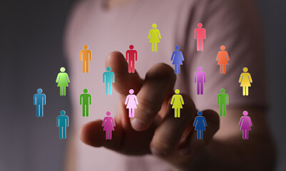 Hand touching colorful figures, representing concepts of community, teamwork, and digital...