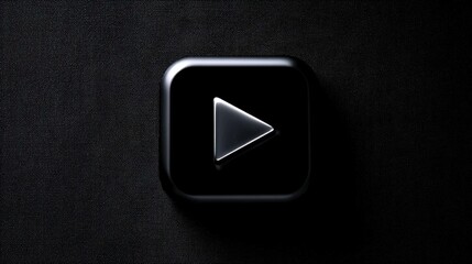 A play button with a triangular shape is set against a dark surface. This symbol represents the way to start or play videos and audio content.