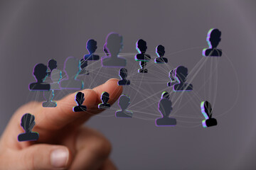 Abstract image showing interconnected network of people with a hand pointing towards. Network connection concep