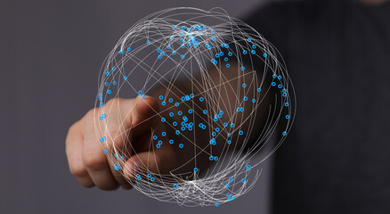 A person's finger points to a 3D digital network globe symbolizing global connection, internet, and data sharing. Perfect for tech, c