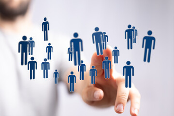 Hand touching digital human icons representing networking, connections, technology, innovation, and teamwork. C