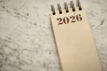calendar page turning from 2025 to 2026, New Year calendar concept. desk calendar flip page for new year celebration 