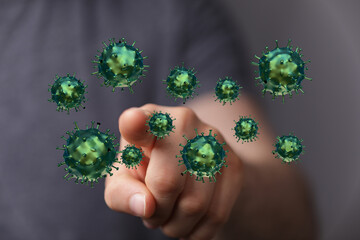 Hand pointing towards abstract Coronavirus cells, visualizing the dangers of a pandemic, contagion, and the on