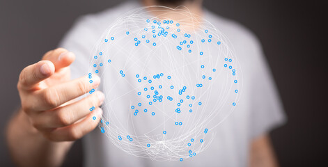 An image of a man holding a digital globe, representing global connection, internet, communication, and technological advancement. A