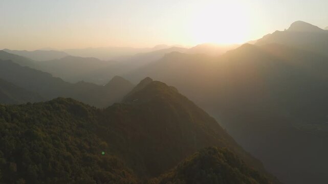 Sunset aerial from Grande Panchina overlooking lake and mountain scenery, Capovalle, Italy