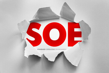 SOE stands for Standard Operating Environment, displayed through torn paper. It represents a standardized set of software and configurations for operating systems across systems or enterprises