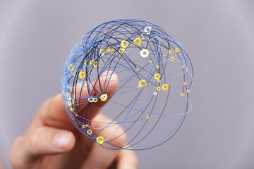 Person's hand touching a digital globe network representing global connection, internet,...