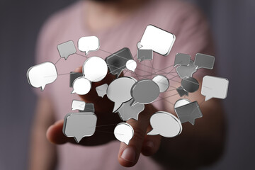 A hand extending with a digital network of speech bubbles. Communication, messaging, social media, and connection.