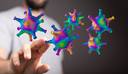 Artistic depiction of colorful coronavirus cells interacting with a human hand, illustrating a concept of scie