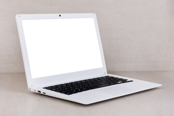 Fototapeta premium white mock up on a white laptop screen on a gray background close-up