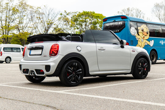 April 13, 2021, Seoul, South Korea - Silver Mini Cooper Convertible JCW parked in a lot with a blue bus and white van in the background