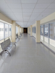 Empty Modern Hospital Hallway with Metal Benches and Bright Windows