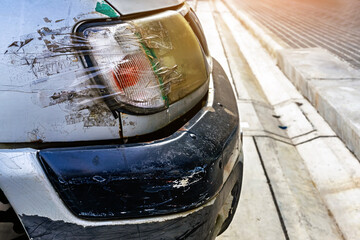 Broken headlight on car and sealed with transparent tape. Broken car headlight repaired with scotch...