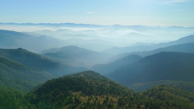 Dreamy fog and sunlight over hills near Ceranesi, Italy