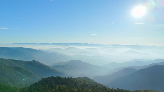 Beautiful fog-filled valley with sunlight in Italian countryside