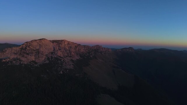 Aerial Continued Slow Approach Towards Western Bucegi Ridge Silhouette at Twilight Part 2